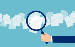 Crop hand of cartoon employer with magnifier looking through candidates resume in search